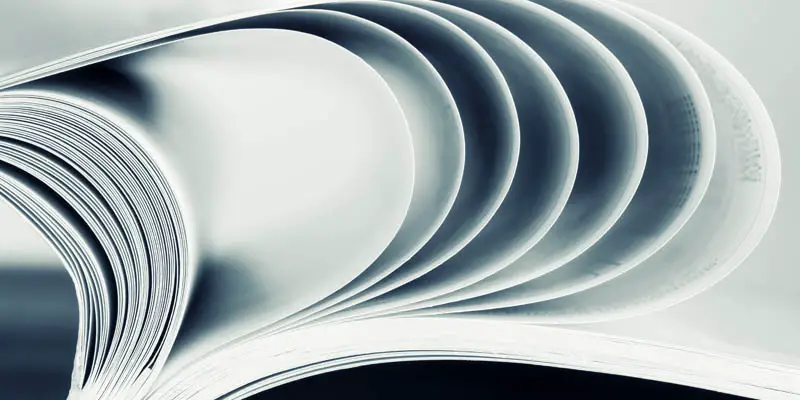 Flipping through a book of documents.