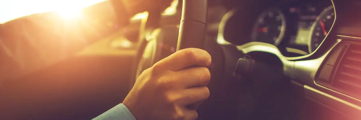 Hands on a steering wheel.